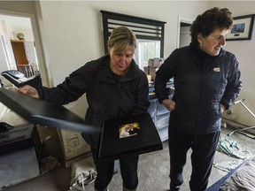 Debra Wilbrink, left, and her mother, Sue Unruh, discovered that Wilbrink's wedding album had survived amid the destruction.
