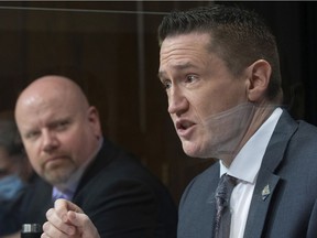 The Quebec minister responsible for the fight against racism, Benoit Charrette, speaks at a press conference on measures to prevent racism on Thursday in the National Assembly.  Minister Ian Lafrenière, left, looks on.