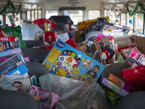 Loads of non-perishable food and toys are packed onto a school bus outside St. Andre Catholic Elementary School on Friday, December 10, 2021. Items collected will be sent to the Children's Aid Society and the Sandwich Teen Action Group.