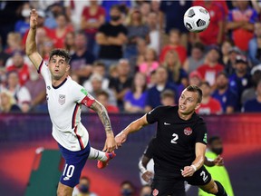 Alistair Johnston of Team Canada, right, defends against midfielder Christian Pulisic of the USA during the first half of CONCACAF World Cup Qualifier at Nissan Stadium in Nashville on September 5, 2021 .