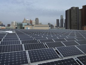 Solar panels are placed on the roof of the Windsor International Aquatic and Training Center on Wednesday, December 8, 2021, with Detroit in the background.