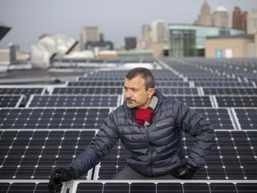 Pictured between rows of solar panels on the roof of the Windsor International Aquatics and Training Center, Sokol Aliko, manager of Energy Initiatives in the City of Windsor, is pictured on Wednesday, Dec. 8, 2021.