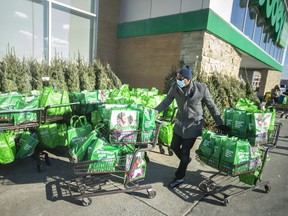 Carts full of donated food for turkey dinners are lined up outside Sobeys in Tecumseh, Wednesday, December 22, 2021. Rock Development donated the turkeys while Sobeys donated $ 4,000 worth of potatoes, canned corn, bread and gravy.