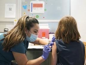 A seven-year-old girl gets vaccinated last month.