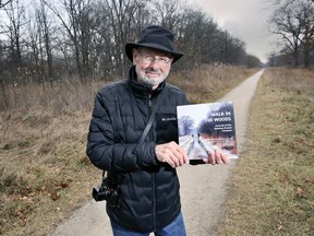 Marty Gervais, Poet Laureate Emeritus of Windsor is shown at the Ojibway Prairie Complex on Thursday, December 9, 2021, with a book he collaborated on titled "Forest Walk: Portrait of the Ojibway Grasslands Complex.