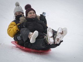 Ivanna Mora, left, and her sister Daniella sled down the hill at Mount Royal and Park Aves.  January 6, 2022.