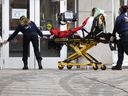 Paramedics bring a patient to the emergency room at Notre-Dame Hospital in Montreal, Thursday, Jan. 13, 2022.