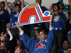 Members of the 'Nordiques Nation' cheer during the NHL game between the New York Islanders and the Atlanta Thrashers on December 11, 2010 at the Nassau Coliseum in Uniondale, NY.  More than 1,100 Quebec fans attended the game to show their support for an NHL team.