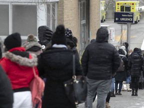 People wait in line on Plessis St. to enter the COVID-19 testing clinic at Notre-Dame Hospital on Wednesday, Dec. 22, 2021.