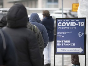 People line up at a COVID-19 vaccination clinic on Parc Ave. in Montreal on Wednesday, Dec. 29, 2021. While there is understandable frustration with people who refuse to get vaccinated because they have embraced falsehoods, forcing them to get vaccinated It would be a mistake, Brian Bird says.