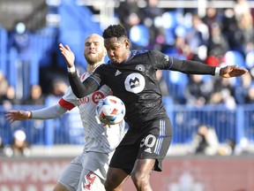Toronto FC's Michael Bradley faces CF Montreal's Romell Quioto, up front, during the first half of the 2021 Canadian Championship match at Saputo Stadium on November 21, 2021 in Montreal.