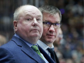 Head coach Bruce Boudreau (left, with assistant coach Scott Walker) says he shares his players' frustration at not being able to play on Saturday.
