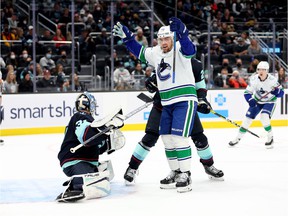 Tanner Pearson of the Vancouver Canucks celebrates a goal from linemate Conor Garland (not pictured) during the third period of their final game, a 5-2 win over host Seattle Kraken last Saturday.