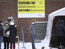 People wait in line at a Parc Ave. COVID-19 testing site in Montreal, Monday, Jan.3, 2022.