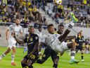 Romell Quioto of CF Montreal attempts an overhead kick as Harrison Afful of Columbus Crew defends during the first half in Columbus, Ohio on September 25, 2021.
