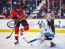 Vancouver Canucks goalkeeper Richard Bachman saves Devante Smith-Pelly from the Calgary Flames during an exhibition game on September 16, 2019 in Calgary. 