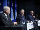 Dr Luc Boileau, left, Quebec's new acting director of public health, is introduced by Prime Minister François Legault with Health Minister Christian Dubé during a press conference in Montreal, Tuesday, January 11, 2022.