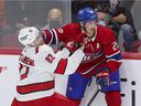 Montreal Canadiens defenseman Jeff Petry holds off Jesperi Kotkaniemi of the Carolina Hurricanes during the first period in Montreal on October 21, 2021.