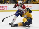 Montreal Canadiens defenseman Alexander Romanov collides with Nashville Predators center Luke Kunin on December 4, 2021 in Nashville.