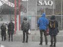 Customers brave the snow outside Jean-Talon Market's SAQ store in 2020.