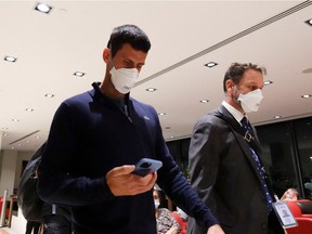Serbian tennis player Novak Djokovic walks at Melbourne airport before boarding a flight, after the Federal Court upheld the government's decision to cancel his visa to play at the Australian Open, in Melbourne, Australia, on January 16, 2022.