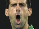 Novak Djokovic of Serbia reacts after a point against Dominic Thiem of Austria during the men's singles final match on day 14 of the Australian Open tennis tournament in Melbourne on February 2, 2020. On January 5, 2022, his visa was revoked for failing to comply with the country's strict pandemic restrictions.