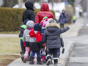 Children from a Laval kindergarten walk down a street on December 3, 2020. Children are not required to wear masks in kindergartens, according to provincial directives.