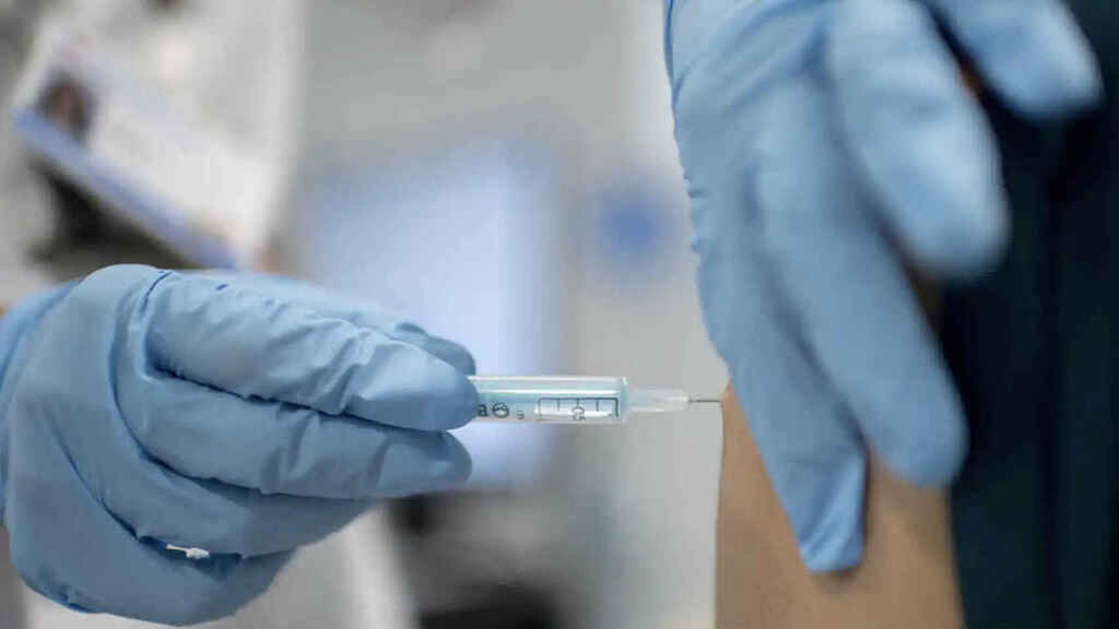 A healthcare professional injects a vaccine into a patient.