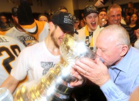 Sidney Crosby and Jim Rutherford, general manager of the Pittsburgh Penguins, drink from the Stanley Cup in the locker room after Game 6 of the 2017 NHL Stanley Cup Final at Bridgestone Arena on June 11, 2017 in Nashville, Tennessee.