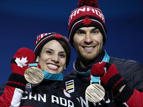 Eric Radford, seen with his ex-partner Meagan Duhamel on the podium at the 2018 Winter Olympics, says that COVID-19 is shaping up to be an 'invisible minefield' for all athletes heading to the Beijing Games.