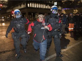 A protester participating in a protest against the curfew in Montreal on January 1, 2022 is kidnapped by the police.