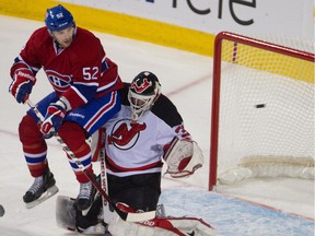 Mathieu Darche of the Montreal Canadiens captures Martin Brodeur of the New Jersey Devils when Lars Eller's shot hits the net at Montreal's Bell Center on December 17, 2011.