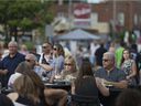 People dine on an extended patio at Vito's Pizzeria during the 15th Annual Walkerville Art Walk, Friday, July 21, 2017.