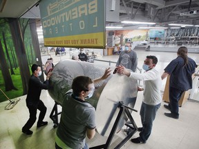 Volunteers spin the barrel of large bills at the Brentwood Recovery Home on Saturday, January 15, 2022, during the organization's 30th annual dream home lottery drawing.