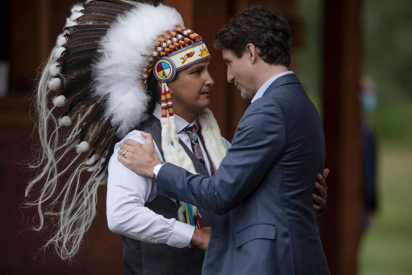 Prime Minister Justin Trudeau speaks with Cowessess Chief Cadmus Delorme during a ceremony to sign the Miyo Pimatisowin Act Coordination Agreement on July 6.
