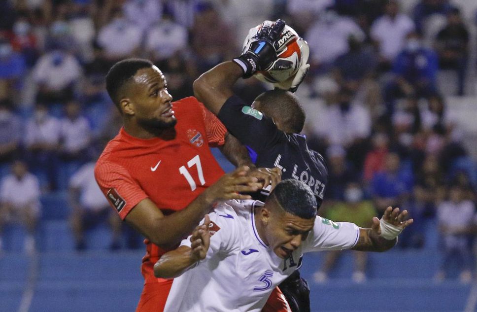 Canada's Cyle Larin fights for the ball against Honduras' Kervin Arriaga, bottom, and goalkeeper Luis Lopez during a World Cup qualifier on Thursday in San Pedro Sula, Honduras.