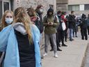 People line up at a COVID-19 testing clinic in Montreal on Wednesday.  Dr. Mylène Drouin said 95 cases of the new Omicron variant have been detected in the city, with many more expected in the coming days.
