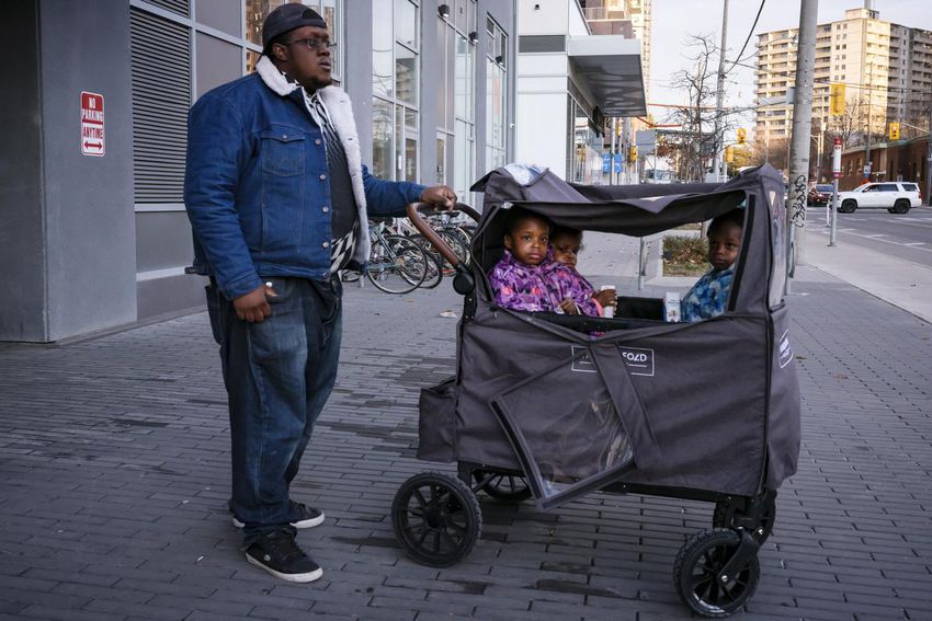 Curtis McCleary, 29, and his three daughters.  McCleary is a single father and widower, raising his girls with the help of his community.