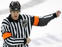 Referee Dave Jackson calls for a hook penalty during a playoff game between the New York Rangers and the New Jersey Devils on April 11, 2008, at the Prudential Center in Newark, New Jersey.