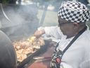 James Morgan grills chicken for everyone at the Emancipation Day celebration in Lanspeary Park on Saturday, August 3, 2019.