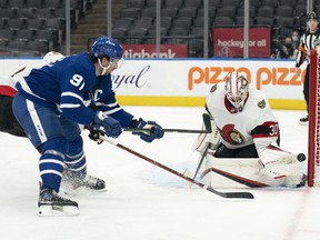 Toronto Maple Leafs center John Tavares (91) looks for the rebound as Ottawa Senators goalkeeper Matt Murray (30) makes the save during the third period at Scotiabank Arena.