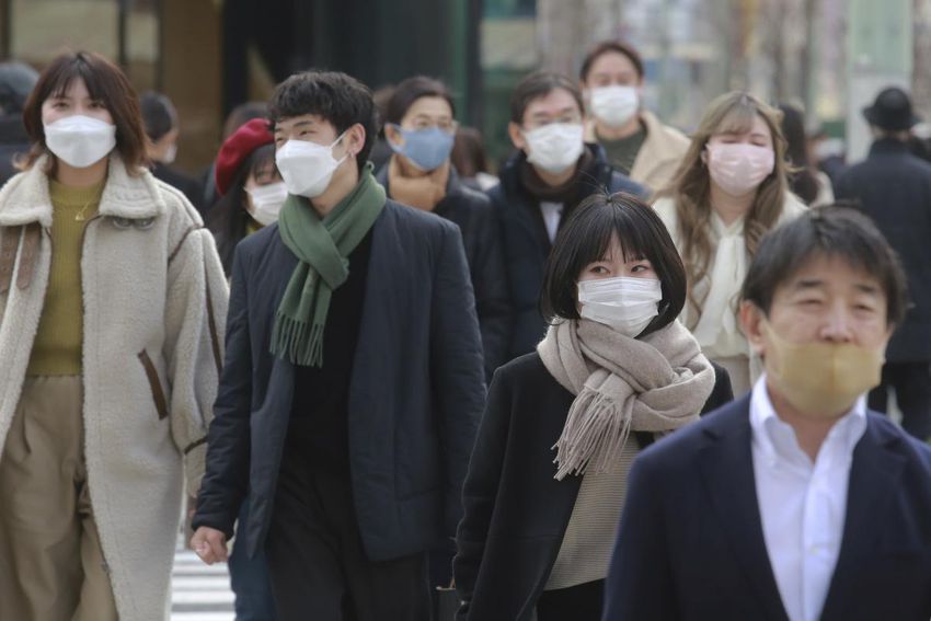 People wearing face masks to protect against the spread of the coronavirus walk on a street in Tokyo this week.