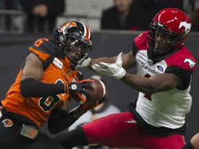 BC Lions cornerback TJ Lee intercepts a pass destined for Calgary Stampeders receiver Hergy Mayala during a 2019 game. The Lions have 11 picks for the year, the second-most in the CFL.