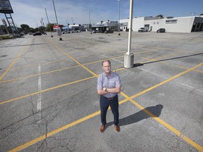 Mickey Pierre, a Gus Revenberg Chevrolet Buick GMC salesman in Windsor, is displayed in a virtually empty sales lot on Thursday, Sept. 30, 2021.