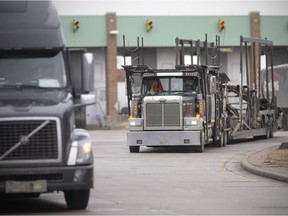 Transport trucks enter Canada after being cleared by the Canada Border Services Agency at the Ambassador Bridge on Friday, January 14, 2022. As of Saturday, unvaccinated truckers are not allowed to cross the Canada-U.S. border. USA