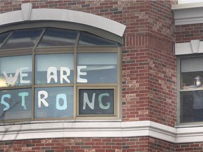 A challenging and hopeful sign is displayed in a window at The Village at St. Clair long-term care home in Windsor on January 5, 2021.