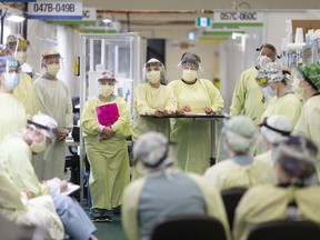 In this May 13, 2020 file photo, frontline medical staff hold a meeting at Windsor Regional Hospital Field Hospital at St. Clair College SportsPlex, at the start of the COVID-19 pandemic.