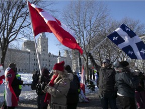 Protesters walk next to Quebec's National Assembly during a protest against COVID-19 vaccines and health restrictions on Feb. 5, 2022.