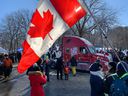 Demonstrators wave Canadian and Quebec flags at a gathering outside the National Assembly to protest against COVID-19 health restrictions in Quebec City on February 5, 2022.