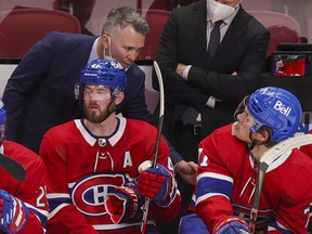 Canadiens interim head coach Martin St. Louis speaks to Jake Evans during the second period Thursday night at the Bell Center.